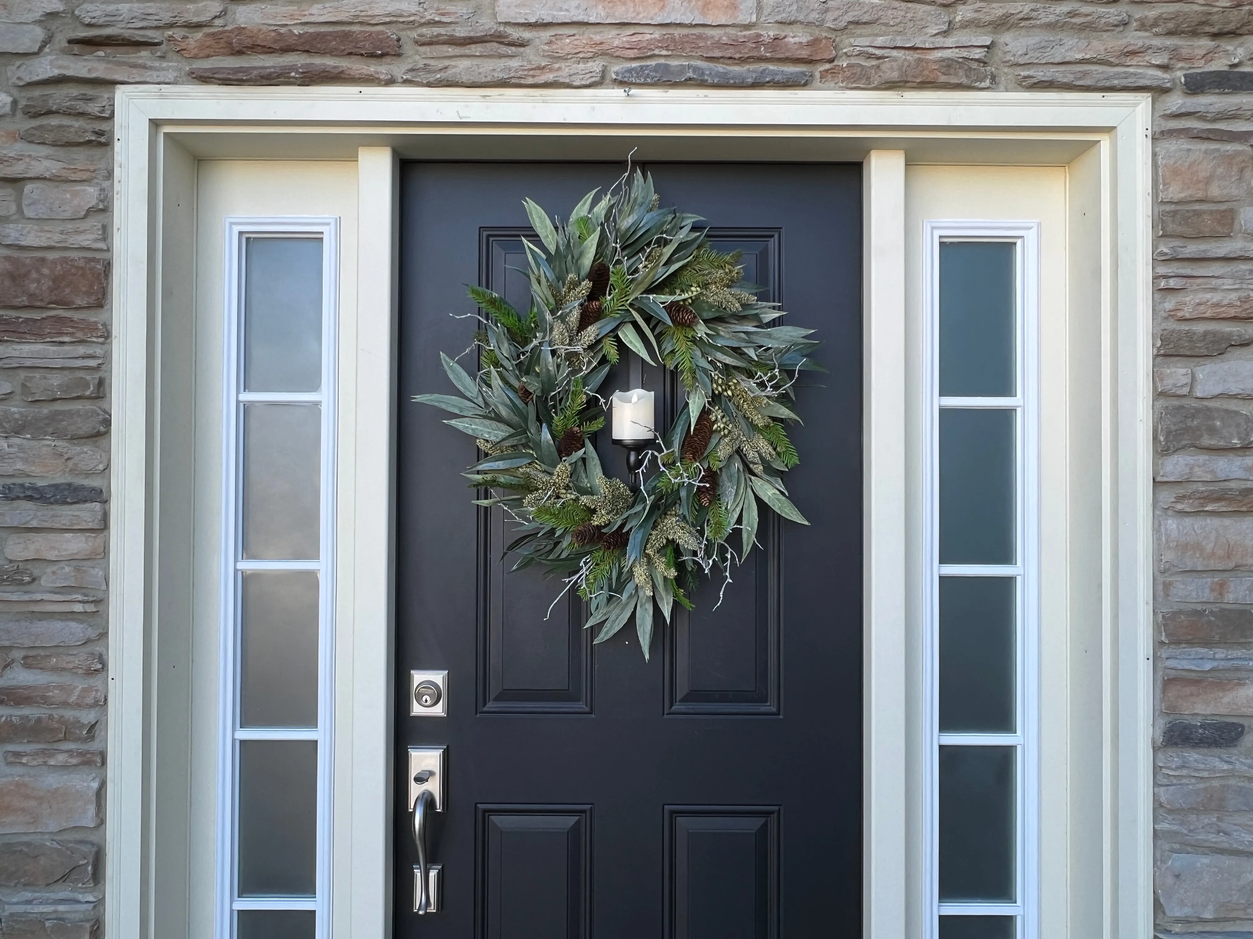 A Christmas Gathering Winter Wreath with Flickering Candle