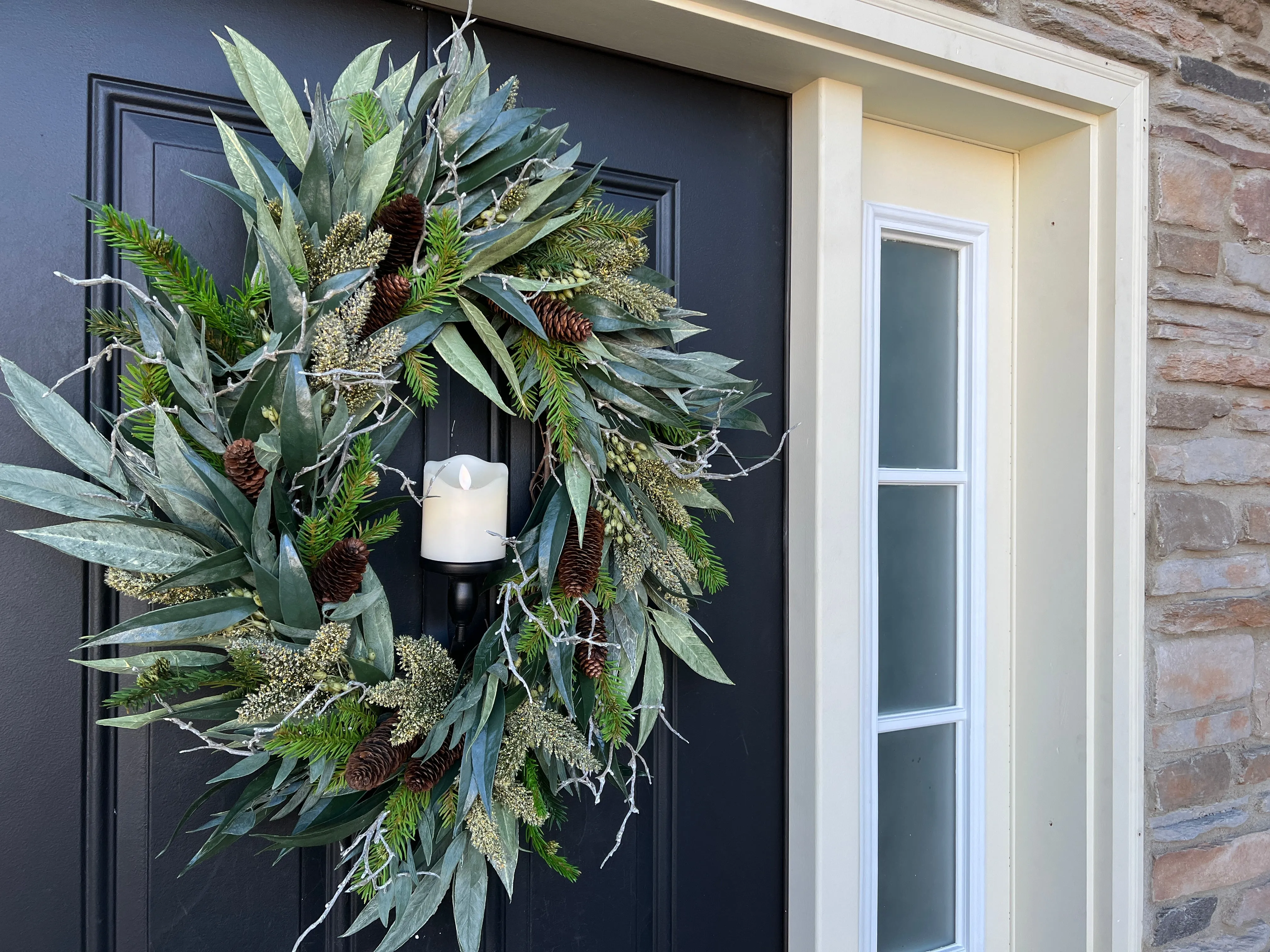 A Christmas Gathering Winter Wreath with Flickering Candle