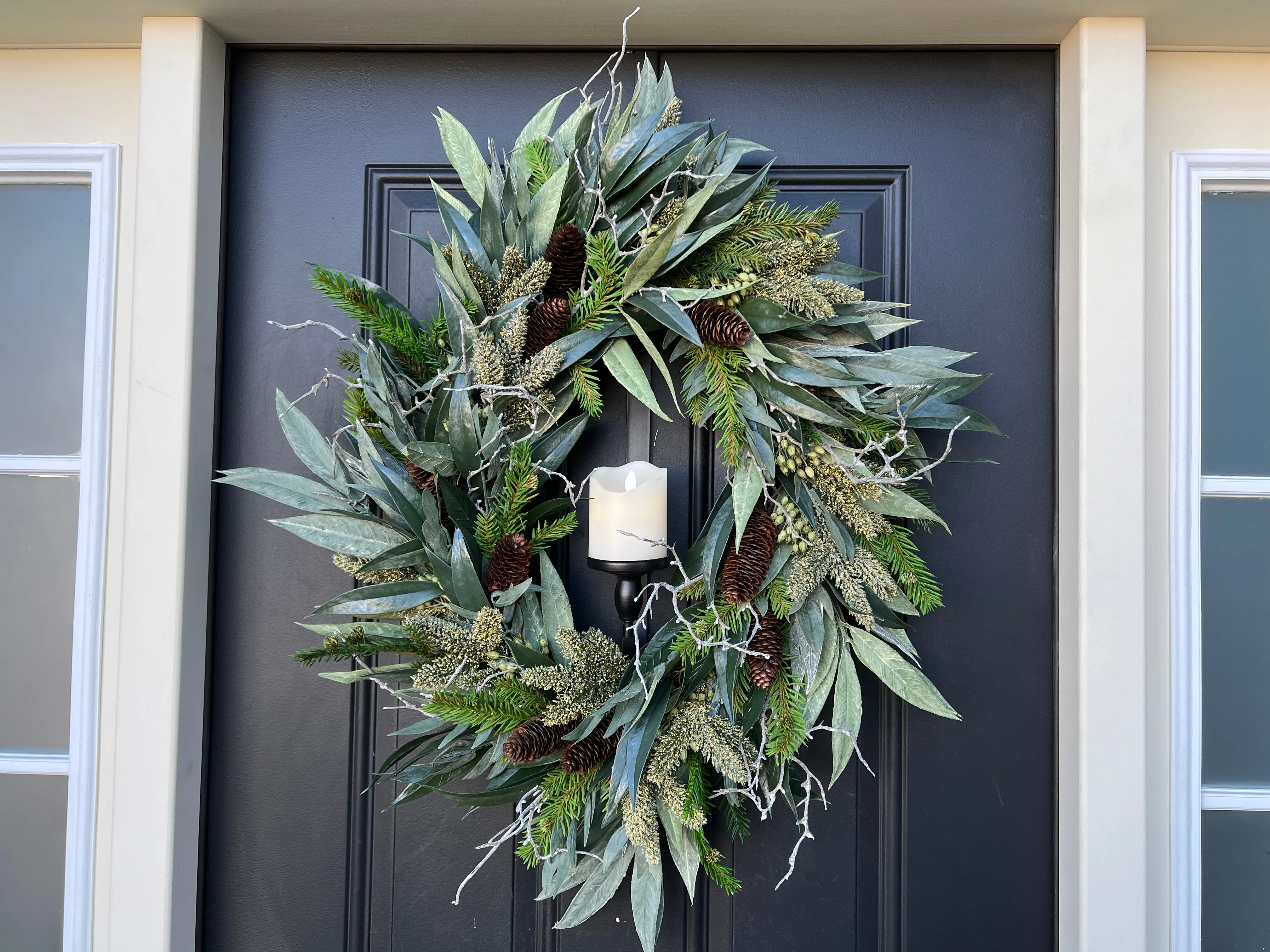 A Christmas Gathering Winter Wreath with Flickering Candle