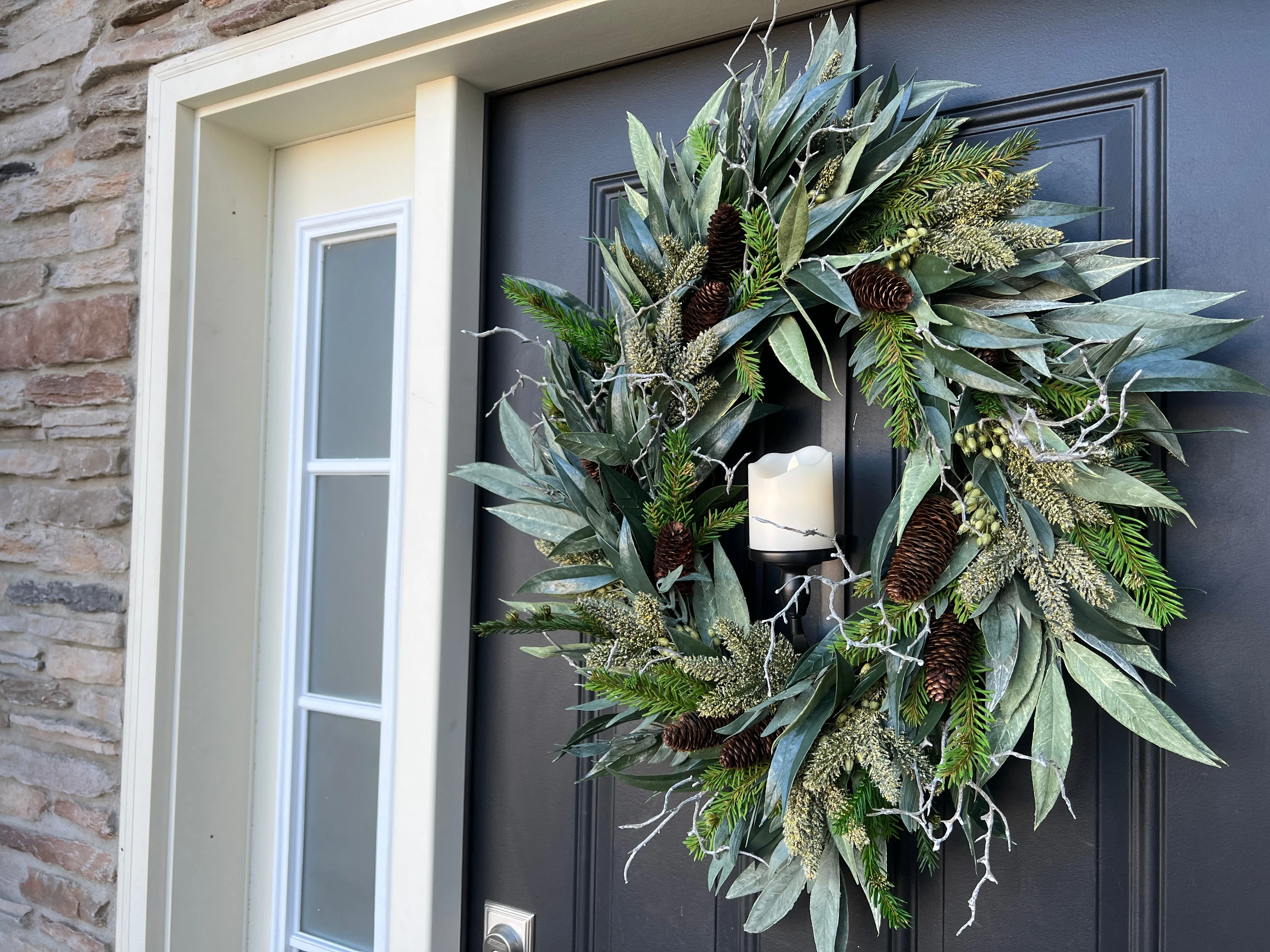 A Christmas Gathering Winter Wreath with Flickering Candle